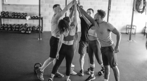 Supportive Exercise Friends High-Fiving After Workout at Gym